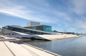 a building next to a body of water at Urban Oslo Penthouse with Fireplace & City Views in Oslo