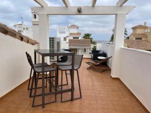 un patio con tavolo e sedie su un balcone di Villa A70 by Alina365 a La Manga del Mar Menor