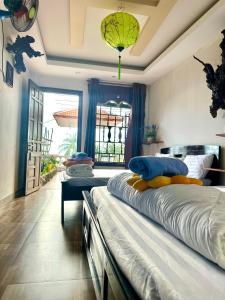 a bedroom with two beds and a large window at NGO KHANH Homestay in Tân Hiệp