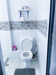 a small bathroom with a toilet and a sink at Imastay in Mombasa