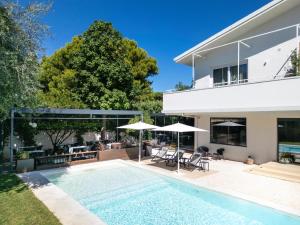 a swimming pool in the backyard of a house at Domìa Boutique Hotel e Cucina in Mondello