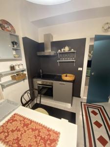 a small kitchen with a stove and a table at A4 in Savona