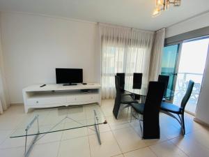 A television and/or entertainment centre at Euromarina Lateral by Alina365