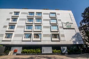 a white building with a sign on it at The Fern Residency Woodland, Pune, Series by Marriott in Pune