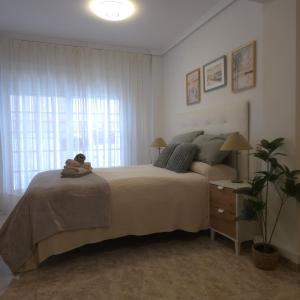 a bedroom with a bed with a teddy bear on it at apartamento alma in Almería