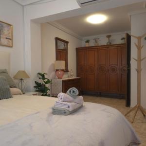 a bedroom with a bed with a towel on it at apartamento alma in Almería