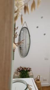 a mirror on a wall next to a table at Mezzaterra 10 tourits accomodation in Feltre +79 photos