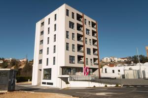 a white building with a lot of windows at Boutique Apartment - Široki Brijeg in Široki Brijeg