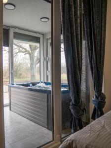 a bedroom with a view of a window at Star INN in Čadjavica