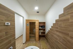 a bathroom with a toilet and a wooden wall at Star INN in Čadjavica +10 photos