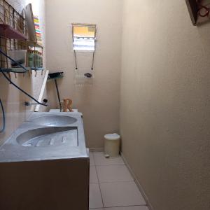 a small bathroom with a sink and a toilet at FL Acomodações in Crato