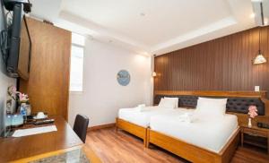 Postel nebo postele na pokoji v ubytování Gigame Signature Hotel