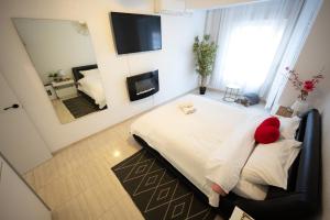 a bedroom with a bed with a teddy bear on it at Alma Brizo Suites in Grao de Castellón +23 photos