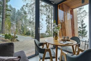 a room with a table and chairs and a large window at Apartament Białka SKI - 200m do Term Bania, blisko natury in Białka Tatrzańska