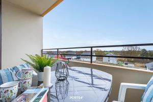 a glass table on a balcony with a view at Ferienwohnung Sydvind 8408 Marina Wendtorf in Wendtorf