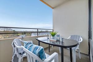 a table and chairs on a balcony with a view at Ferienwohnung Sydvind 8408 Marina Wendtorf in Wendtorf