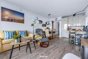 a living room with a couch and a table at Ferienwohnung Sydvind 8408 Marina Wendtorf in Wendtorf +11 photos