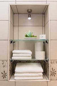 a shelf in a bathroom with towels on it at Zagreb Central in Zagreb