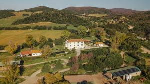 an aerial view of a white house on a hill at Agriturismo Morani in Santa Severa