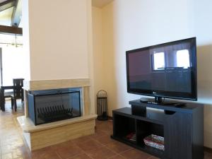 A television and/or entertainment centre at Private Villa 102 with heated pool in BlackSeaRama