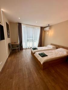 a hotel room with two beds and a window at Music Flats in Sofia