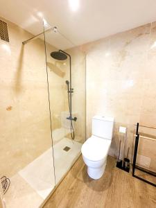 a bathroom with a toilet and a glass shower at Ibiza Port Rooms in Ibiza Town +1 photo