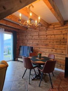 a dining room with a table and chairs at Noclegi Panorama - Domek RUSTIC in Ustrzyki Dolne +13 photos