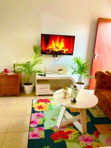 a living room with a living room with a fireplace at Softlife Home Classic Studio 2 in Mombasa +2 photos