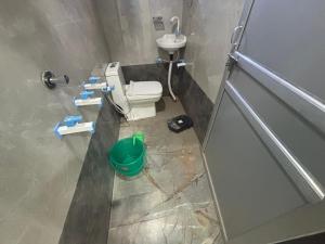 a bathroom with a toilet and a sink at Yuvraj Guest house in Khātu +11 photos