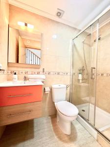 a bathroom with a toilet and a shower and a sink at Adosado Mar Serena in San Juan de los Terreros +13 photos