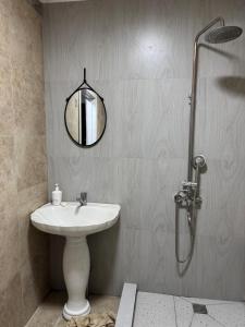 a bathroom with a sink and a shower with a mirror at DelLuna in Almaty +33 photos