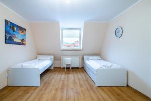 Posteľ alebo postele v izbe v ubytovaní Victus Apartamenty, Apartament Fala Bałtyku