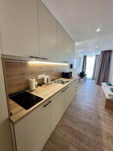 a kitchen with white cabinets and a counter top at Music Flats in Sofia +42 photos