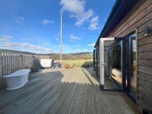 a deck with a sliding glass door on a house at The Tin Shed in Rhayader