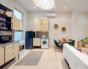 a kitchen and living room with a table and chairs at K8 Syntagma in Athens +16 photos