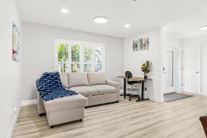 a living room with a couch and a table at Gulf Breeze Haven Direct Gulf Access Pool+Dock in Cape Coral +53 photos