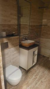 a bathroom with a toilet and a sink at hotel pearl wood in Zirakpur