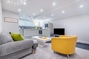 a living room with a couch and a yellow chair at Garden Mews - 2 double bedrooms - Harrogate Holiday Apartments in Harrogate