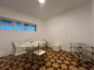a white room with a table and chairs in it at Cuxipa House in Sao Paulo
