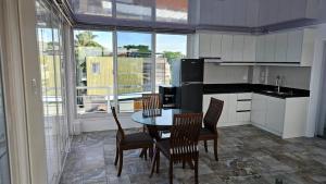a kitchen with a table and chairs in a kitchen at Lydias House samal kaputian in Kaputian