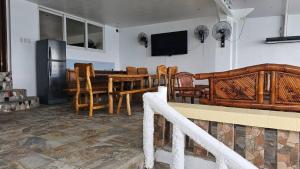 a kitchen and dining room with a table and chairs at Lydias House samal kaputian in Kaputian