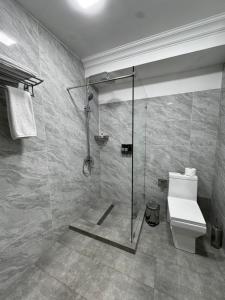 a bathroom with a shower and a toilet at Mir Luxe Plaza in Tashkent