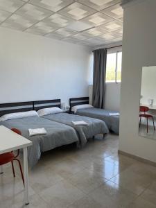 Postel nebo postele na pokoji v ubytování Hostal Kaizen
