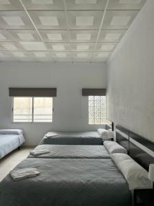Postel nebo postele na pokoji v ubytování Hostal Kaizen