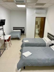Postel nebo postele na pokoji v ubytování Hostal Kaizen