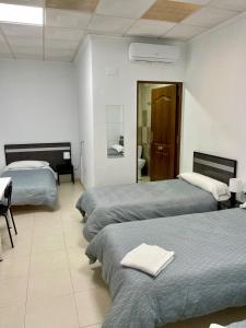 Postel nebo postele na pokoji v ubytování Hostal Kaizen