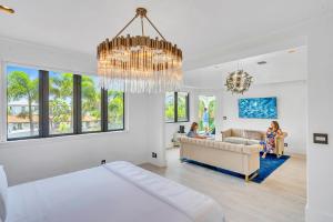 フォート・ローダーデールにあるVenice of America Heated Pool Canal View Access Isle Key VlLLASのシャンデリアのあるリビングルームに座る女性2名 +38枚の写真
