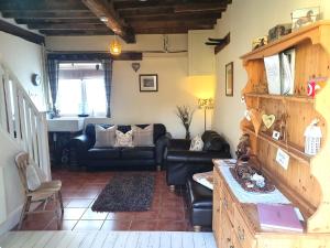 a living room with a couch and a table at Forest Farm Papplewick Nottingham - Spacious Self-Contained Rural Retreat! in Papplewick