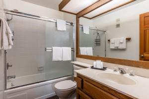a bathroom with a sink and a toilet and a shower at Mountainback 19 Loft Den in Mammoth Lakes +19 photos