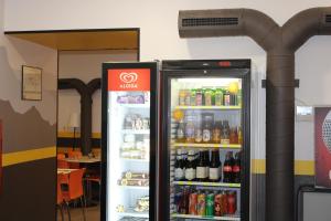 a refrigerator filled with lots of drinks at Roma Scout Center in Rome